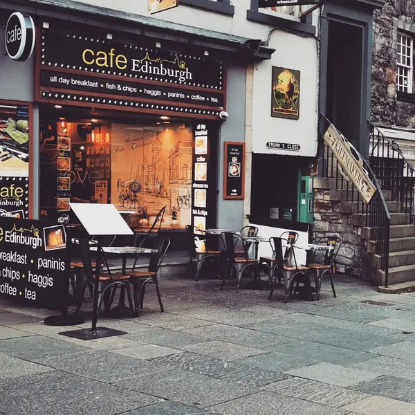 Old Town buildings on a grey morning, with tables set out along the pavement